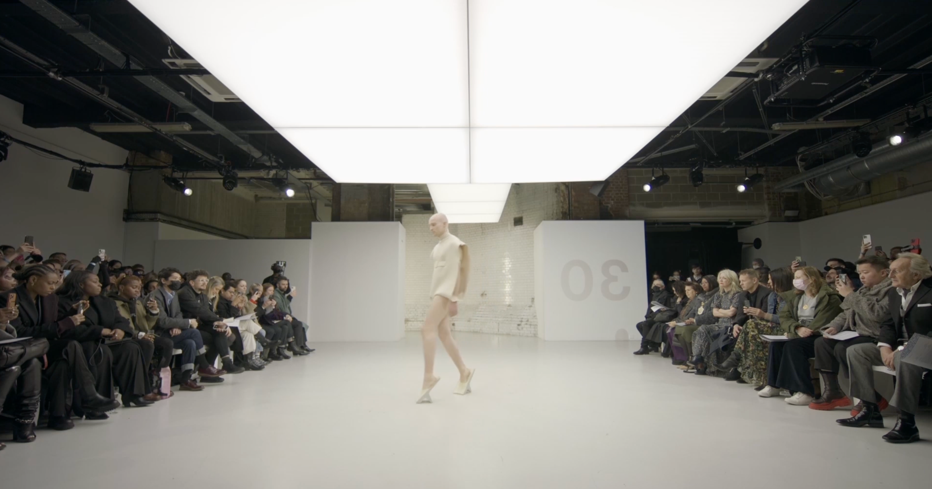 Load video: Collection designed by Dirk Vaessen, Shown at London Fashion Week 2022. This collection has gone viral worldwide. The collection shows people walking differently because of the shoes and garments they wear.